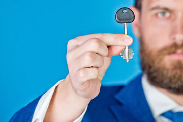 key in hand of businessman or man in suit