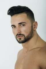 Obraz premium Handsome sexy man with unshaven face, beard and stylish hair