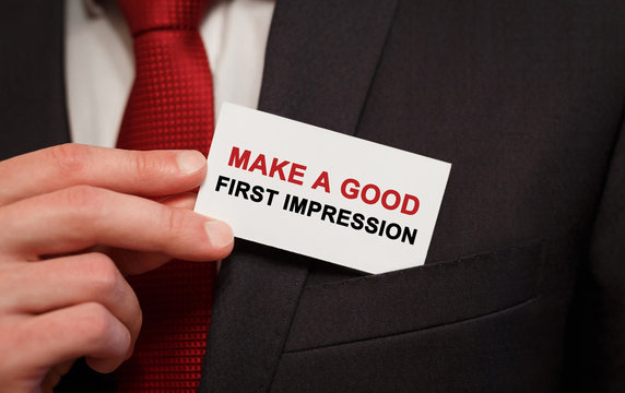 Businessman Putting A Card With Text Make A Good First Impression In The Pocket