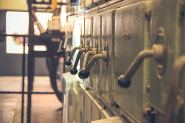 Ancient levers on a control panel machine in a factory