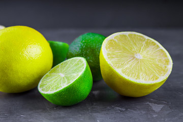 lemons and limes on a gray background