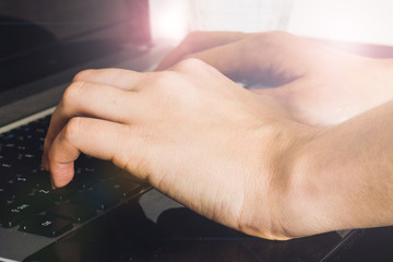 Woman working at home office hand on keyboard close up