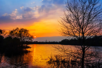 Fototapeta na wymiar quiet lake scene at the sunset