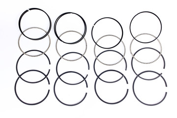 Spare parts for car piston rings on white isolated. New original equipment spare parts