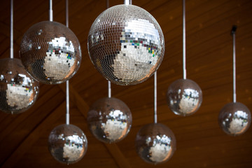 Mirror disco balls hanging. Reflections, dance and celebration.