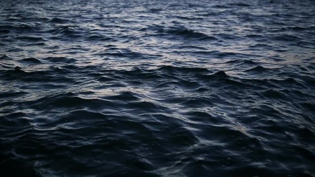 tiny rough waves. Dark blue water