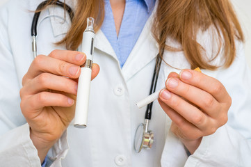 Doctor is comparing an e-cigarette and tobacco cigarette