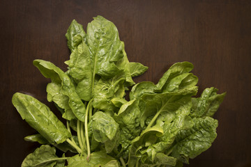 Spinach on table. Fresh organic raw produce on a kitchen table.