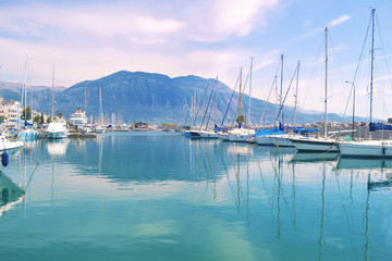 Fototapeta na wymiar sailboats reflected on sea Kalamata port Greece