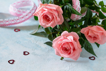 Background wedding, mother's day or birthday. A bouquet of fresh pink rose flowers on a blue background. Copy space.