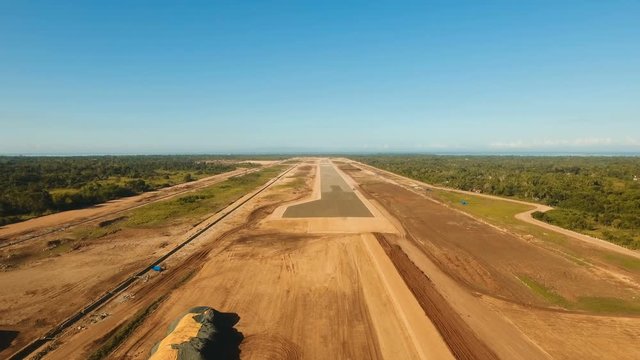 Construction of a new airport terminal on Panglao. Aerial view Modern airport terminal construction site. Construction of a landing strip on the island of Bohol, Philippines. Landing strip. 4K video