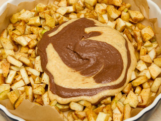Pouring cinnamon powder into apple filling. Making Filo Pastry Topped Apple Pie Series.