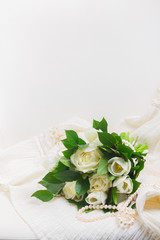 white fresh rose and tulips flowers on white chair with lace dress, with copy space