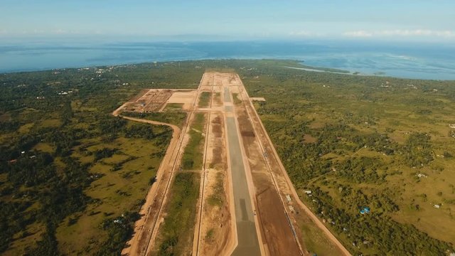 Construction of a new airport terminal on Panglao. Aerial view Modern airport terminal construction site. Construction of a landing strip on the island of Bohol, Philippines. Landing strip. 4K video