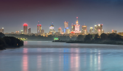 Night panorama of Warsaw skyline, Poland, over Vistula river in the night