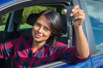 Woman showing car key through open window