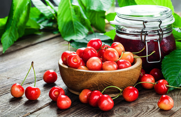 Fresh cherries in bowl on table