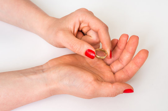 Female hand with wedding ring - divorce concept