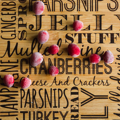 Frozen cranberries on a Christmas chopping board