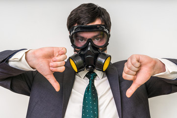 Businessman with gas mask is showing negative gesture