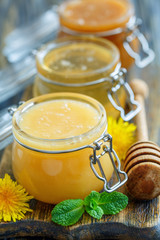 Different varieties of honey in glass jars.