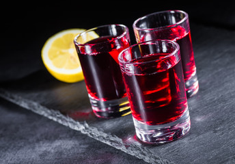 Fresh red juice cocktail with pomegranate seeds and ice