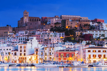 Ibiza Dalt Vila downtown at night with light reflections in the water, Ibiza, Spain.