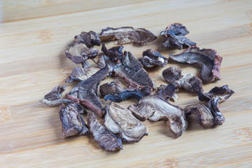 Dried porcini mushrooms on a wooden table. Food background.