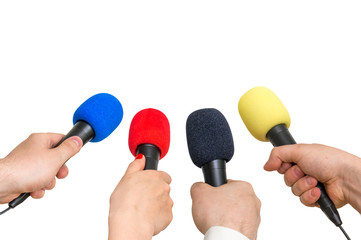 Hands of reporters with many microphones