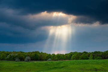Sunrays over the stormy field