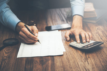 man hand calculator and documents