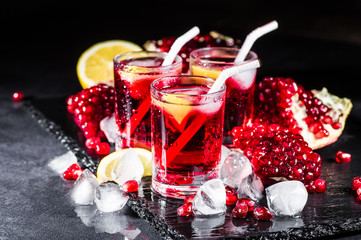 Fresh red juice cocktail with pomegranate seeds and ice