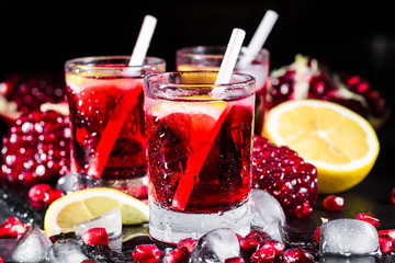 Fresh red juice cocktail with pomegranate seeds and ice