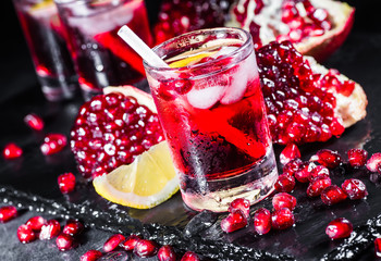 Fresh red juice cocktail with pomegranate seeds and ice
