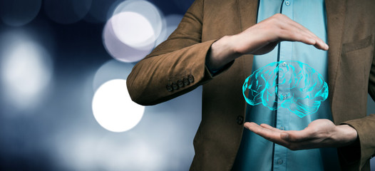 businessman hand holding brain in palm