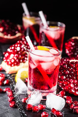 Fresh red juice cocktail with pomegranate seeds and ice