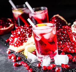 Fresh red juice cocktail with pomegranate seeds and ice