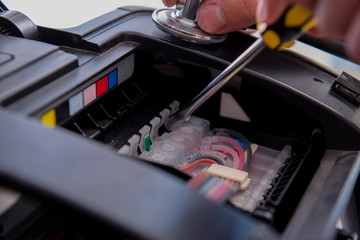 Repairman repairing broken color printer