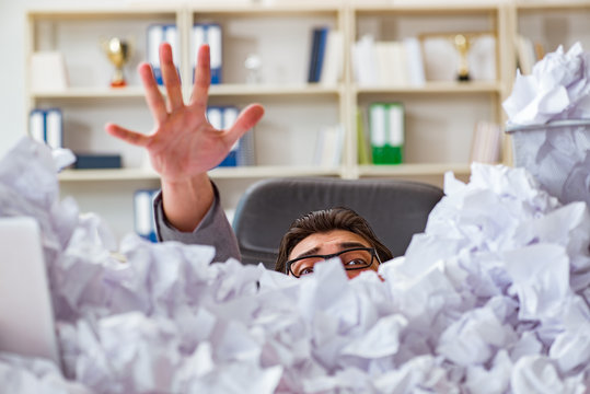 Businessman In Paper Recycling Concept In Office