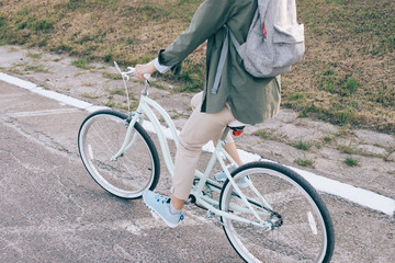 Naklejka premium Slender woman rides a bicycle on the road