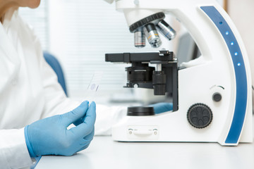 Senior female scientist using a microscope in her research
