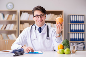 Doctor in dieting concept with fruits and vegetables