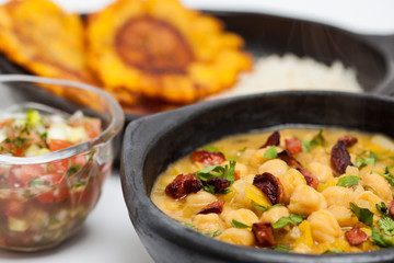 Chickpeas with sausage served with patacon and rice