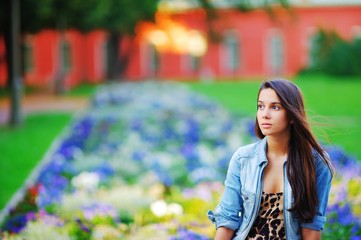 Portrait of a dreamy cute woman meditating outdoors, with effect of blur, closeup.