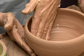 Process of making clay bowl on pottery wheel