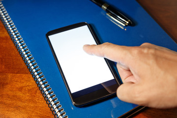 black cellphone and notebook