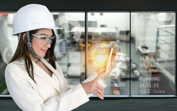 Smile Young Asia Female Engineer Using Tablet , Wear Glasses And White Hat In Smart Factory Industrial With Real Time Monitoring System Industry Ui Screen . Industry 4th Internet Of Things Concept.