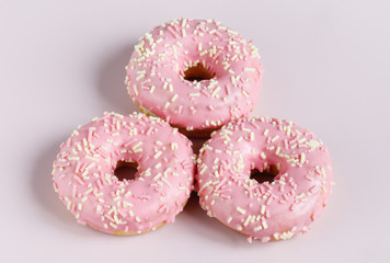 Pink donut on plain background