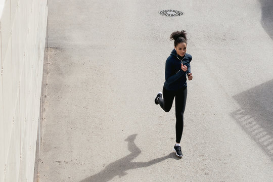 High angle view of female runner on city street
