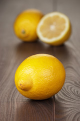 fresh lemons on the brown wooden table